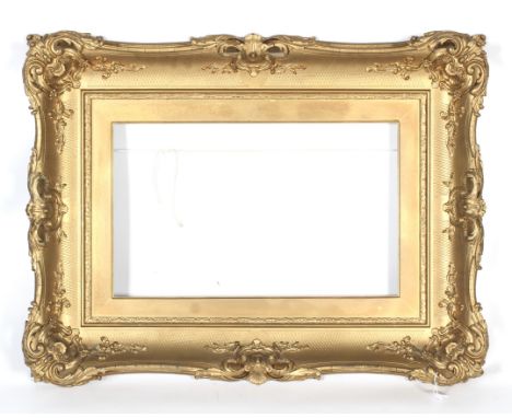 An early 20th century giltwood neo-rococo picture frame. With pierced rocaille frame moulded with shells and hatched pattern,