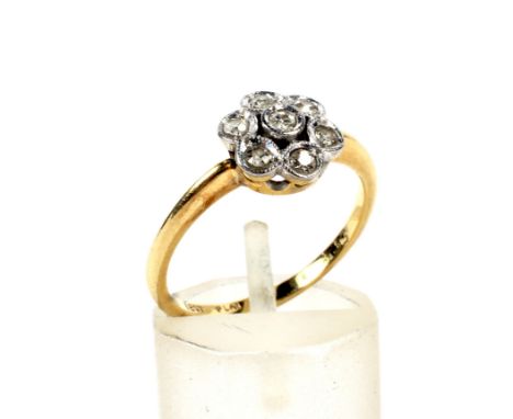 An early 20th century gold and diamond seven stone flower-head cluster ring. The single-cut diamonds all grain set within whi