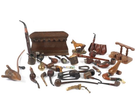 A large assortment of 20th century pipes and related items. Various styles, including carved wooden examples, also including 