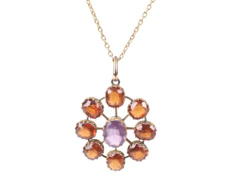 An early 20th century hessonite garnet and violet paste star-shaped cluster pendant and a chain. The pendant centred with an 