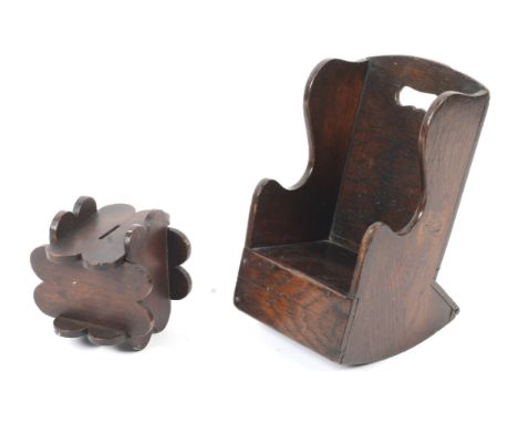 A 19th century style oak Apprentice lambing wing back elbow rocking chair and an oak puzzle money box. The first  H24.5cm