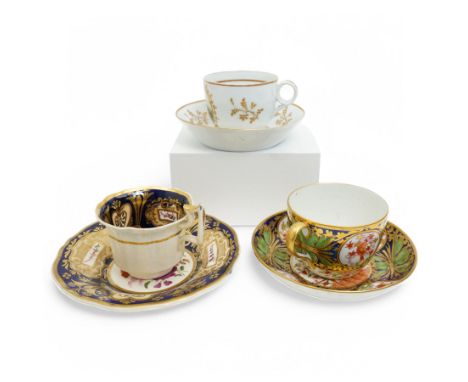 19th century teacup and saucer, possibly Coalport, decorated with panels of flowers on a cobalt blue ground with gilt decorat