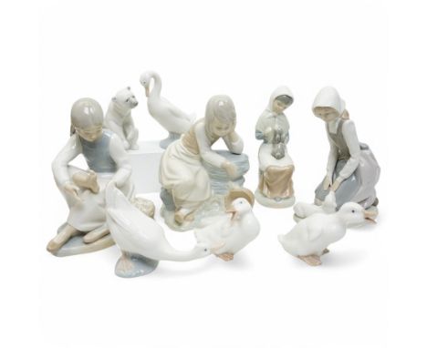 A group of eight Nao figures, together with one Lladro Polar Bear figure, each with printed mark beneath (9)
