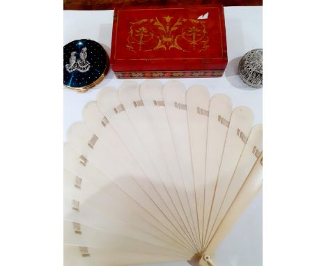 An early 20th Century ivory fan with coat of arms to one fan wand and on the other side of one wand the initials E.G and a cr