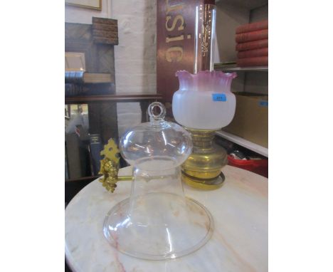 A part Victorian brass wall hanging oil lamp with later frosted glass shade with cranberry pink edge, and smoke funnel, along