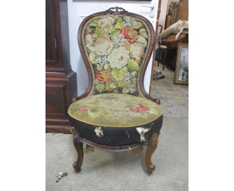 A Victorian walnut framed spoon back chair with a tapestry back and seat 