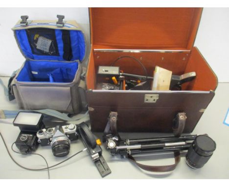 An Olympus OM-1 camera, together with accessories contained in two cases 