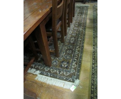 A WOOL RUG the light brown and blue ground panel with poly chrome diamond medallions within a conforming border 200cm x 297cm