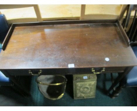 A GEORGIAN MAHOGANY SIDE TABLE the rectangular top with moulded three quarter gallery above two frieze drawers with brass dro