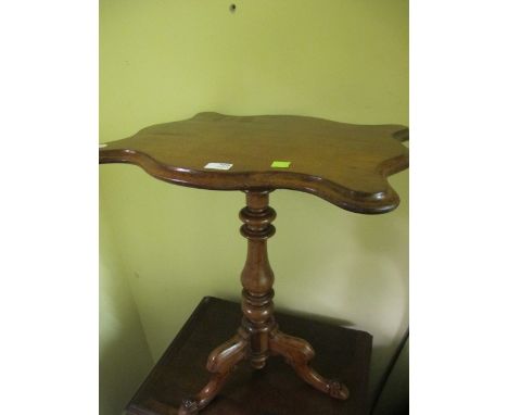 A VICTORIAN MAHOGANY WINE TABLE the serpentine moulded top above a baluster column on tripod support