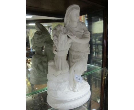 A BISQUE FIGURE modelled as a female shown standing holding a sickle and a sheaf of wheat raised on an oval base 34cm high