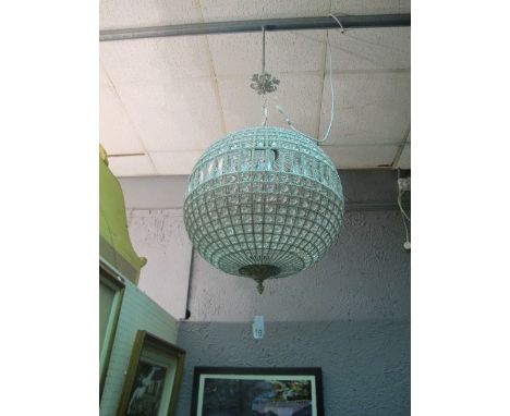 A CONTINENTAL CUT GLASS AND BRASS CENTRE LIGHT of bulbous form decorated with cut glass faceted pendants