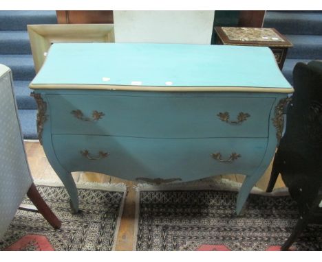 A CONTINENTAL BLUE PAINTED AND PARCEL GILT COMMODE of bombe outline the shaped moulded top above two frieze drawers between p