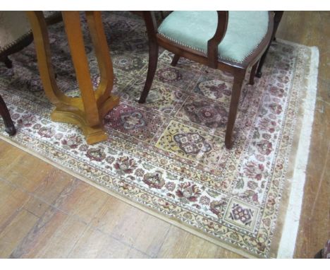 A WOOL RUG the beige light brown and green ground with panels filled with palmets within a floral border 236cm x 153cm