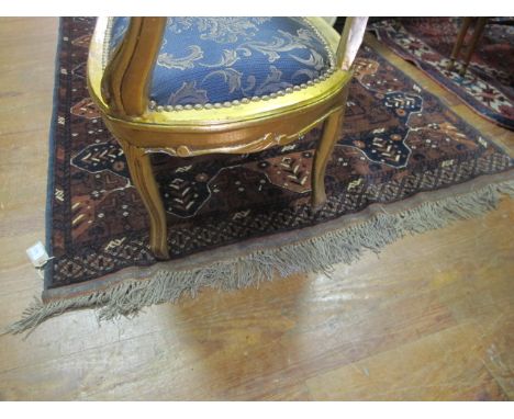 A BOKHARA WOOL RUG the light brown and indigo ground with stylized flowerheads within a three strand conforming border 183cm 