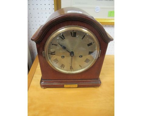 A MAHOGANY CASED MANTLE CLOCK the rectangular arched dial with silver dial and Roman numerals raised on brass bun feet 28cm h