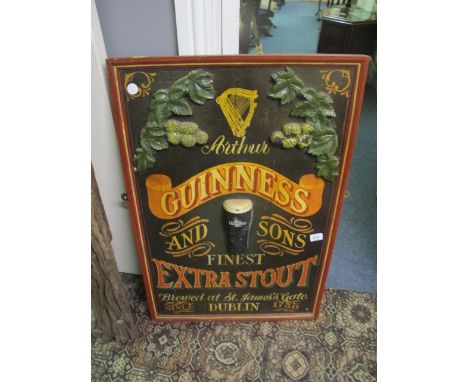 A PINE AND POLYCHROME GUINNESS ADVERTISING SIGN inscribed "Arthur Guinness and Sons Finest Extra Stout Brewed at St James Gat