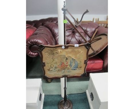A VICTORIAN ROSEWOOD FIRESCREEN with needlework panel raised on a baluster column and circular spreading foot (panel AF)