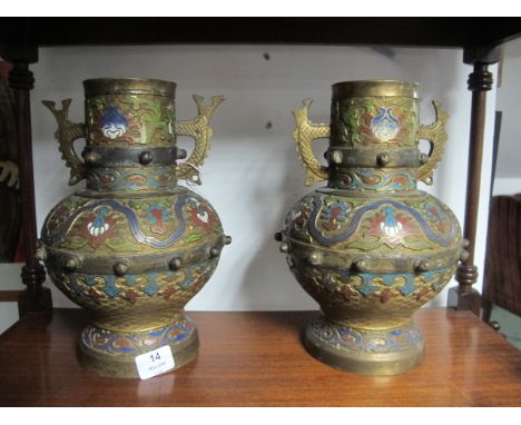 A PAIR OF ORIENTAL BRASS AND ENAMEL VASES each of baluster form decorated with  wine and turquoise panels with knobbed bandin