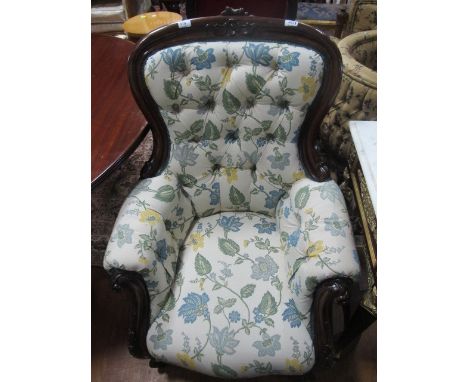 A GOOD VICTORIAN MAHOGANY GENTS CHAIR the curved top rail carved with stylized flowerhead above a deep button upholstered bac