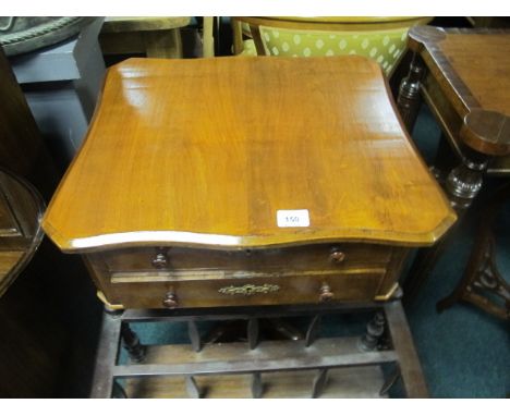 A CONTINENTAL WALNUT TABLE of serpentine outline the shaped moulded top above two frieze drawers above a baluster column on t