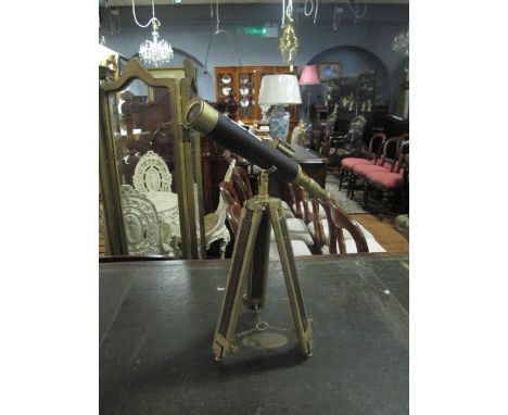 A BRASS AND LEATHER BOUND TABLE TOP TELESCOPE raised on telescopic tripod support telescope 43cm long