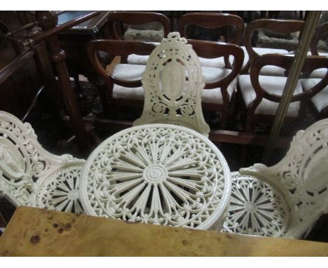 A FOUR PIECE CAST IRON PATIO SUITE comprising three chairs each with an oval cameo back with ribbon tied cresting above a pie