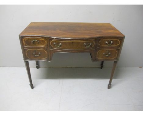 A GOOD GEORGIAN MAHOGANY SIDE TABLE of serpentine outline the shaped moulded top above two short and one long drawer with bra