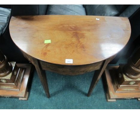 A GEORGIAN MAHOGANY SIDE TABLE of demi-lune outline the shaped moulded top above a plain frieze on square tapering legs 71cm 