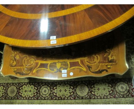 A CONTINENTAL MARQUETRY COFFEE TABLE of serpentine outline the shaped moulded top with brass banding raised on cabriole legs 