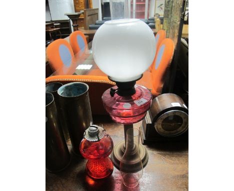 A VICTORIAN BRASS AND RUBY OIL LAMP together with another oil lamp