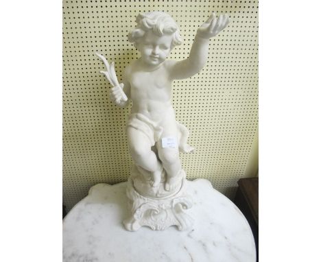 A BISQUE FIGURE modelled as a putti shown seated on a naturalistic base raised on scroll pedestal 162cm high