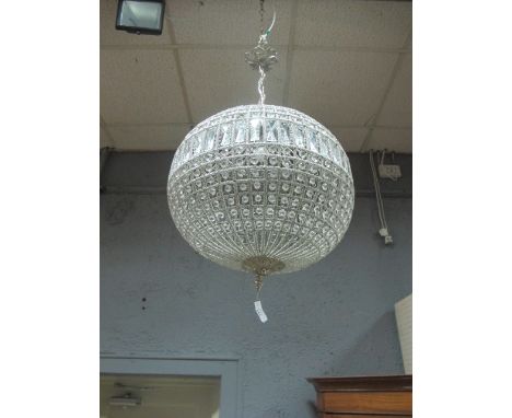 A CONTINENTAL CUT GLASS AND BRASS CENTRE LIGHT of bulbous form decorated with cut glass faceted pendants
The buyer of this lo