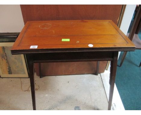 AN EDWARDIAN MAHOGANY FOLD OVER CARD TABLE the rectangular hinged top raised on square tapering legs 71cm (h) x 69cm (w) x 40