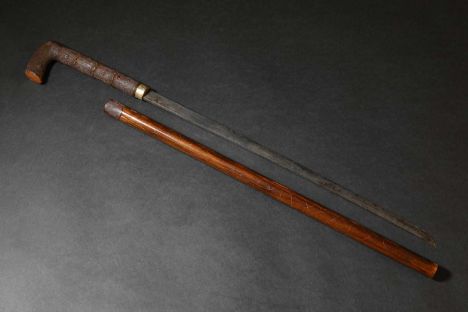 A Japanese swordstick, Meiji, 19th century, with a wooden saya (scabbard), and faux bamboo handle,blade 54cm long79cm long wi