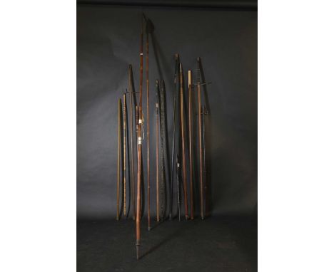 A collection of Japanese yari poles,of varying forms, including crossbar examples, and a walking or swagger stick, with abalo