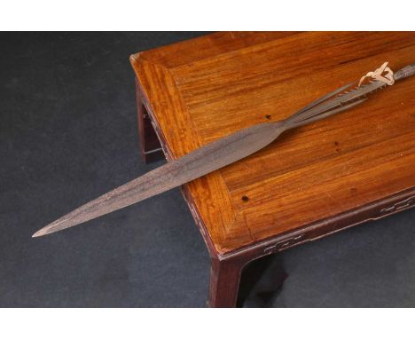 An African spear,19th century, with a barbed spearhead complete with scabbard,spear head 62cm longShipping Disclaimer:Buyers 