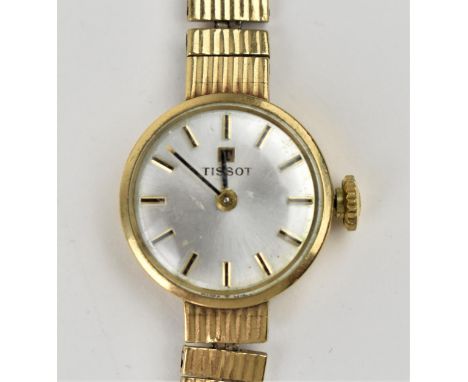 A Tissot manual wind, ladies 9ct gold having a silvered dial with baton hour markers, 9ct gold bracelet and buckle, the 17 je