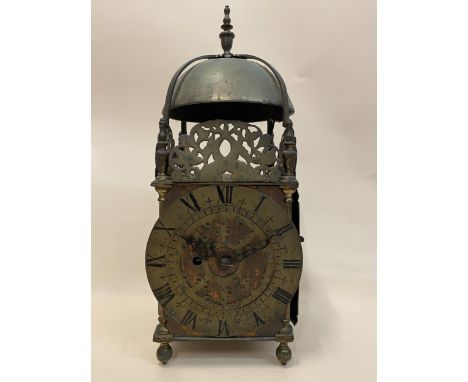 A 17th century and later brass lantern clock, the dial with a pierced centre and Roman numerals surmounted by pierced frets, 