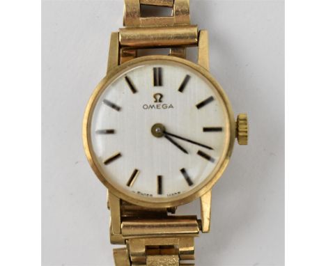 An Omega ladies 9ct gold manual wind wristwatch having a silvered dial with baton markers, the calibre 620 movement having 17