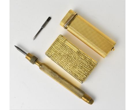 A French Cartier trinity rings gold plated lighter, with engine turned body, together with a Flaminaire lighter with gilt bar