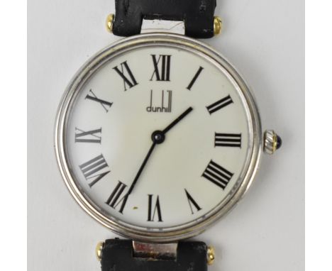 A Dunhill manual wind, wristwatch, the white enamel dial with black Roman numerals, and black baton hands, the two piece scre