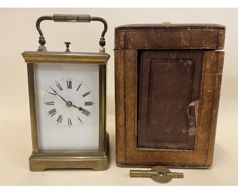 A late 19th/early 20th century brass cased repeater carriage clock, white enamel dial with Roman numerals, the 8 day movement