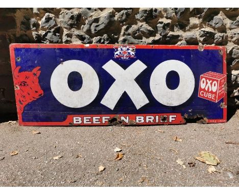 A vintage 'OXO Beefin Brief' advertising enamel sign, with white lettering on a blue ground with red enamel cow, 121 cm x 46 