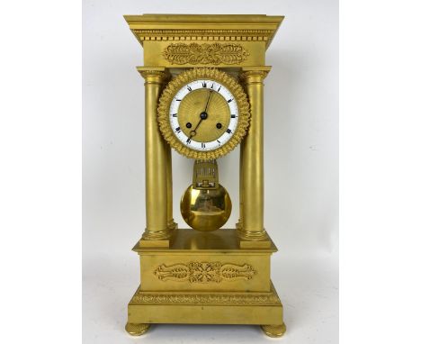 A 19th century French Empire style gilt metal portico clock, the 4" dial having a engine turned centre, Breguet style hands a