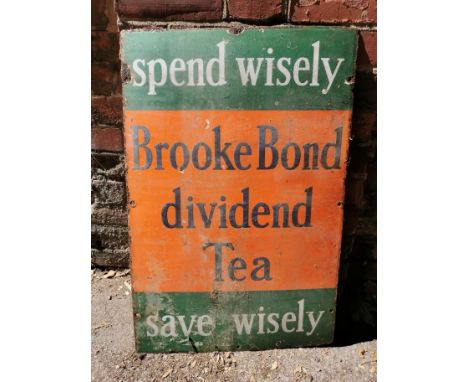 A vintage 'Spend Wisely Brooke Bond divided Tea Save Wisely' advertising enamel sign, with white and black lettering on a gre