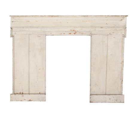 A cream painted wood fire surround, mid 18th century and later re-painted, the protruding mantel shelf above the moulded frie