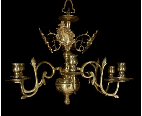 A Dutch or English brass six-light chandelier, elements mid-18th century, of small proportions, the branches terminating in s