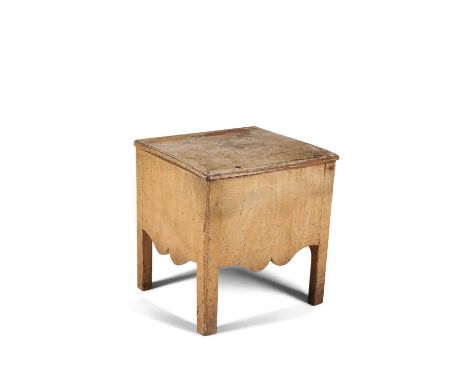 A George III cream painted bedside commode, circa 1800, the hinged rectangular top with moulded edge, above the shaped frieze