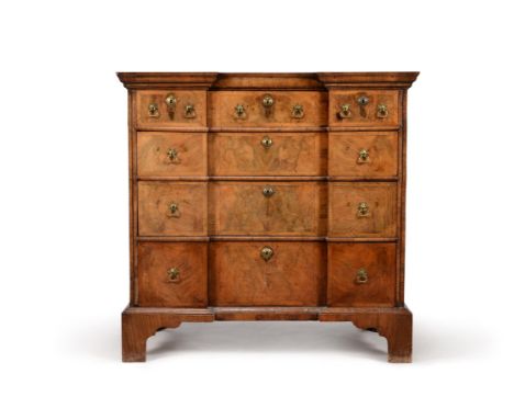 A George II walnut chest of drawers, circa 1740, of reverse breakfront outline, the shaped top with moulded edge, above four 